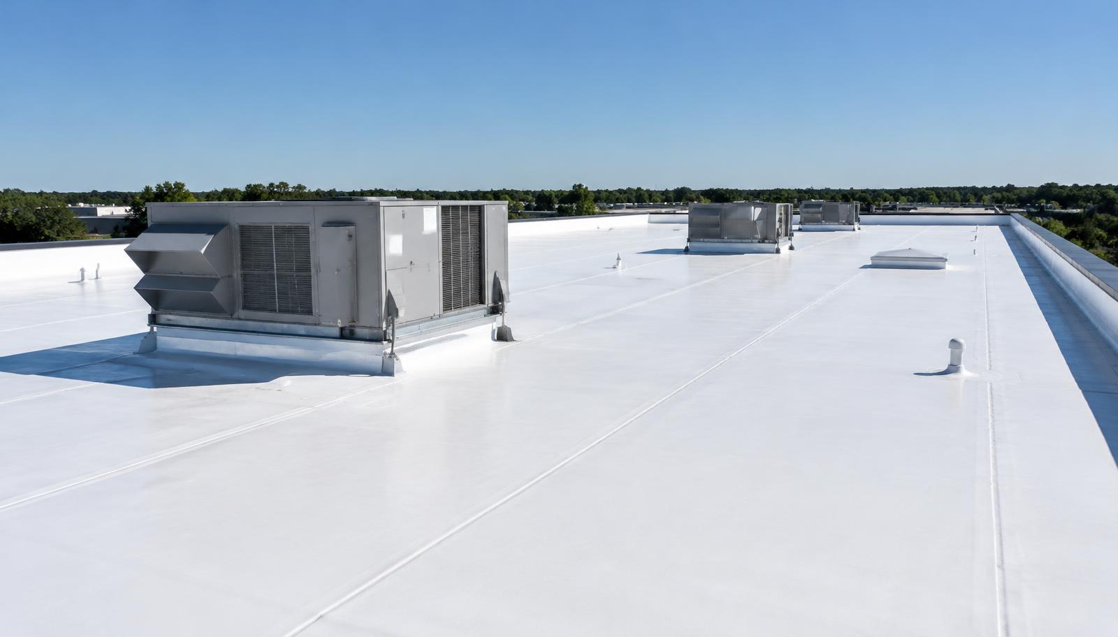 White single-ply membrane roof with rooftop HVAC units on a commercial building